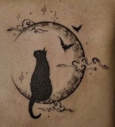 a black cat sitting on top of a moon