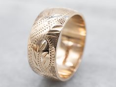 So many wonderful details come together to give this vintage band a rich, textural feel! Crafted of 14 karat yellow gold, this is a great band for stacking or wearing traditional as a wedding band!Metal: 14K Yellow GoldWidth of Band: 8.0 mmHeight off Finger: 1.4 mmRing Size: 6Marks: “<14K>” Stamped on the inside band 14k Gold Jewelry With Intricate Design For Marriage, Heirloom 14k Gold Ring With Decorative Band, Heirloom Ring With Decorative Band In 14k Gold, Yellow Gold Wedding Band With Decorative Detail, Yellow Gold Wedding Ring With Decorative Band, Heirloom Rings With Decorative Band, Yellow Gold Open Band With Diamond Cut, Vintage Wide Band Yellow Gold Jewelry, Vintage Thick Band Wedding Jewelry