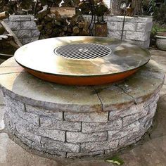 a fire pit sitting on top of a stone wall