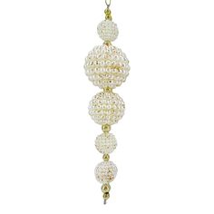 three white pearls hanging from a gold - plated chain, with beads and chains attached to