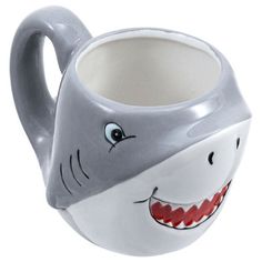 a mug with a shark face painted on it