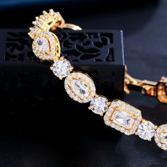 A beautiful piece of remarkable elegance, this exquisite bracelet will add a touch of sophistication to any wedding gown or formal ensemble. Adorned with flawlessly faceted cubic zirconia that captures the light from every angle with a perfectly translucent appeal, the bracelet is rhodium / rose gold / yellow gold plated for a flawless finish which perfectly enhances the intricate detailing and conveys a modern take on old elegance. Length: 7" (approx. 17.8cm); Width: 0.3" (approx. 0.8cm). Closu Diamond Cut Cubic Zirconia Crystal Bracelet, Elegant Cubic Zirconia Crystal Bracelet With Diamond Cut, Elegant Cubic Zirconia Bracelet With Diamond Cut, Elegant Diamond Cut Cubic Zirconia Crystal Bracelet, Crystal Bracelet With Diamond Cut, Dazzling Diamond Cut Bracelets For Party, Elegant Diamond Crystal Bangle Bracelet, Elegant Diamond Crystal Bracelet With Brilliant Cut, Glamorous Cubic Zirconia Jewelry With Diamond Cut