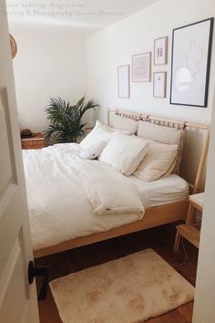 an open door leading to a bedroom with a bed and rug on the floor in front of it