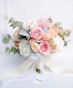 a bridal bouquet with pink and white flowers