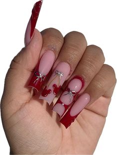 someone is holding their nails with red and white designs