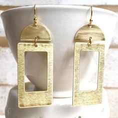 This is a pair of large geometric earrings. Bohemian style brass shapes dangle from simple gold plate ear wires. These statement earrings measure approx 2 1/4 inches from the top of the ear wire to the bottom of the charms. Your lovely item will arrive in a cute beige cotton drawstring gift bag with a gift tag. Perfect for gift giving or a fun little treat for yourself. This jewelry bag can be re-purposed to hold your jewelry while traveling, use it in your purse as a makeup bag or you can put s Modern Gold Oblong Earrings, Gold Square Metal Earrings, Gold Rectangular Earrings For Everyday, Gold Rectangular Everyday Earrings, Gold Brass Rectangular Earrings, Gold Rectangular Brass Earrings, Rectangular Brass Jewelry In Gold-tone, Gold-tone Brass Rectangular Jewelry, Modern Rectangular Brass Earrings