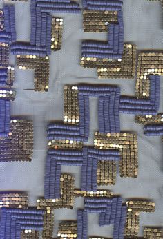 a blue and silver fabric with gold sequins