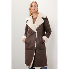 Brown faux shearling (100% Polyester). Jacket. Long sleeves. Collar. Front button closure. 40.5" from shoulder to hemline. Imported. Shearling Fur Coat With Long Sleeves For Work, Shearling Outerwear With Faux Fur Lining, Long Coat, Faux Fur Outerwear With Button Closure, Chic Shearling Outerwear For Fall, Fall Outerwear With Faux Fur Lining And Lapel Collar, Fall Long Sleeve Fur Coat With Double Button Closure, Fall Shearling Outerwear With Button Closure, Shearling Long Coat For Work, Shearling Long Sleeve Outerwear For Fall