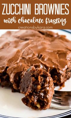 a close up of a piece of chocolate frosted brownie on a plate with a fork