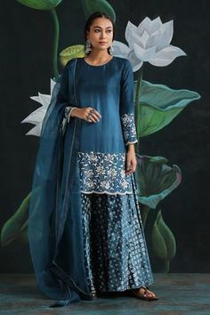 Teal blue kurta with beaded floral embroidery at the hem and scallop edge. Comes with printed velvet palazzo and organza dupatta.
Component: 3
Printed, Embroidered
Neckline: Round
Sleeve Length: Full
Fabric: Crinkled Cotton, Satin, Organza
Color: Blue
Straight kurta
Cotton lining
Delicate bead highlights at the neckline
Scallop edged hem and sleeves
Printed palazzo
Beaded scallop edged dupatta - Aza Fashions Silk Kurta Set, Flared Palazzo, Kurta Cotton, Blue Kurta, Kurta Set For Women, A Line Kurta, Silk Kurta, Organza Dupatta, Embroidered Neckline