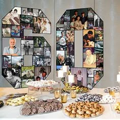 a table topped with lots of food next to a wall covered in pictures and candles