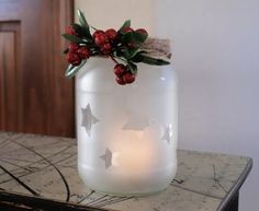 a glass jar filled with candles on top of a table