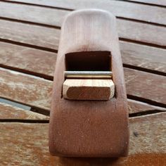 a close up of a wooden object on a wood floor with one piece missing from it