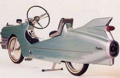 an old model motorcycle with a side car attached to the front wheel and passenger seat