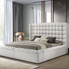 a bedroom with a bed, nightstands and mirror in it's center area