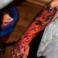 a man's arm with flames on it