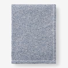 a blue and white blanket folded on top of each other in front of a white background