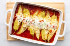 stuffed zucchini shells with sauce and cheese in a casserole dish