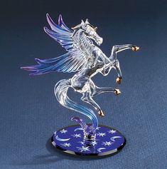 a glass figurine of a horse with wings on it's hind legs