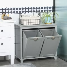 a gray cabinet with two bins and a basket on top next to the sink