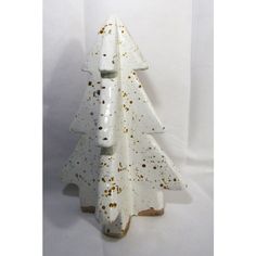 a white ceramic christmas tree with gold speckles on it's bottom and sides