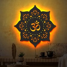 an illuminated sign with the word om shanti on it in front of a table