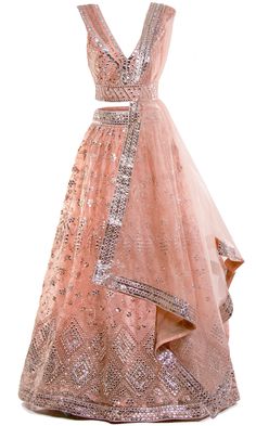 Peachy pink lehenga set with shimmering silver mirror work all through-out. Comes with a chic matching belt to tie around the shawl and your waist! Pink Cutdana Lehenga For Party, Pink Sequined Anarkali Set For Eid, Glamorous Pink Lehenga For Party, Glamorous Pink Dress With Zari Work, Bollywood Style Pink Sequined Lehenga, Pink Sequined Choli For Eid, Pink Sequined Anarkali Set For Navratri, Designer Peach Lehenga With Mirror Work, Elegant Pink Choli With Mirror Work