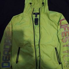 Neon Green Windbreaker With Zipper Front Closure Trendy Windbreaker With Drawstring Hood For Streetwear, Yellow Long Sleeve Hooded Jacket For Streetwear, Trendy Hooded Windbreaker For Sports, Trendy Hooded Sports Outerwear, Spring Yellow Outerwear With Drawstring Hood, Trendy Spring Windbreaker For Streetwear, Sporty Yellow Hooded Jacket For Streetwear, Casual Yellow Hooded Jacket For Fall, Trendy Spring Streetwear Windbreaker