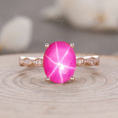 a pink ring sitting on top of a wooden table