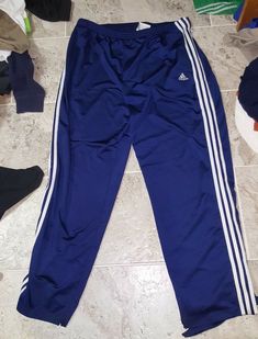 Nice pair of vintage Adidas tear away basketball sweatpants in men's size large. These pants have snap on buttons that run all the way down the pants. On both sides of the pants I did picture where the button at the top is missing. Overall the pants are in very good condition, judge for yourself. The pants also have pockets and a zippered back pocket. You can tell its vintage because Adidas no longer has tags that look like that. Here's your chance to own a sweet pair of pants that cannot be fou Cotton Relaxed Fit Pants With Adidas Logo, Relaxed Cotton Adidas Pants, Adidas Relaxed Fit Sweatpants With Three Stripes, Adidas Relaxed Fit Moisture-wicking Bottoms, Adidas Logo Cotton Jogging Pants, Adidas Cotton Jogging Pants, Cotton Adidas Logo Pants For Jogging, Blue Sweatpants With Three Stripes For Streetwear, Blue Sweatpants With Side Stripes For Streetwear