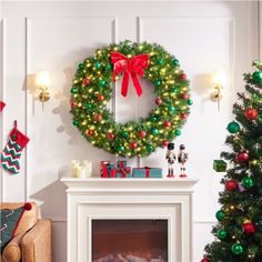 a decorated christmas tree in front of a fireplace with a wreath on the mantel