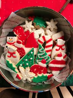 a bowl filled with christmas cookies on top of a table