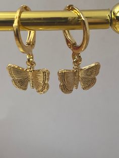 18k gold plated butterfly earrings  Hoop size is 10mm and is 18k gold plated over brass  Charm is 18k gold plated and has a brass base size of butterfly is 14mm These are also available in a dangly version  Earrings come in an organza bag  Please keep earrings away from all liquids and creams Butterfly Charm Hoop Jewelry Gift, Trendy Hoop Earrings With Butterfly Charm As Gift, Gold Hoop Earrings With Butterfly Charm, Gold Hypoallergenic Butterfly Hoop Earrings, Butterfly Charm Huggie Earrings As Gift, Gift Butterfly Charm Huggie Earrings, Butterfly Charm Hoop Earrings As Gift, Gold Huggie Earrings With Butterfly Charm, Trendy Butterfly Hoop Earrings As Gift