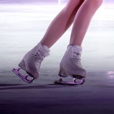 the legs and feet of a woman on roller skates in front of an ice rink