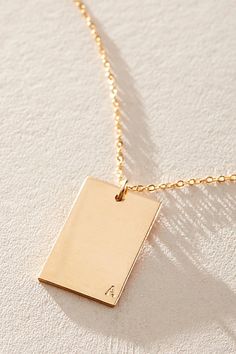 So unique in an understated design, this stunning necklace features a personalized rectangle pendant with initial engraved at corner for a super fun finishing touch. * 14k Gold Filled * 0.5x0.75" rectangle bar necklace with hand-stamped personalization * Length: 20" * 5 days of production | Set & Stones Personalized ie Necklace at Free People in Gold Rectangle Gold Necklace, Rectangle Pendant, Stunning Necklace, Jewellery Design, Bar Necklace, Boho Outfits, Hand Stamped, Free People, Gold Filled