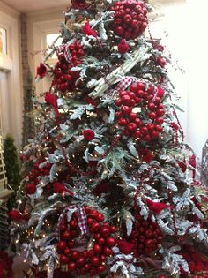 a christmas tree decorated with red and silver ornaments