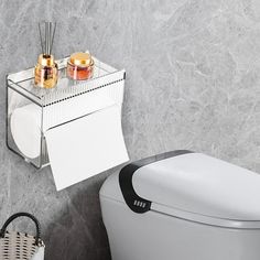 a white toilet sitting in a bathroom next to a towel rack