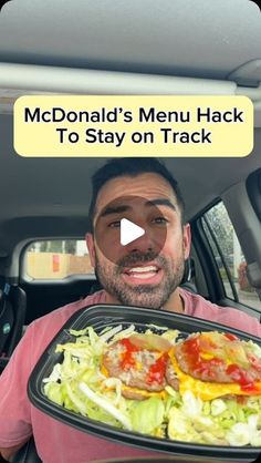 a man holding a tray full of food in the back seat of a car with an ad on it