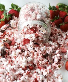 strawberries and marshmallows are mixed together in a jar