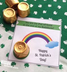 there is a card and some gold coins on the table with shamrocks around it