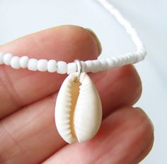 Shell Choker White Choker Necklace White Beaded Choker Summer Necklace Sea Choker Beach Jewelry Dainty and elegant all white beaded choker with glass tiny seed beads and a real shell pendant. DESCRIPTION Made from 2mm glass seed beads and closes with a silver plated clasp and 2 inches adjustable chain. SIZE Necklace is 13 inches and can be adjusted up to 15 inches with a 2 inches extender chain. Shell is around 1 inch long or 2.5 cm. Please let me know if you would like a different length. WRAPP White Beaded Jewelry For Beach Wedding, Handmade White Jewelry For Beach Wedding, Diy Necklace Easy, White Choker Necklace, Eyeglass Jewelry, White Beaded Necklace, White Choker, Seed Bead Choker, White Beaded Necklaces