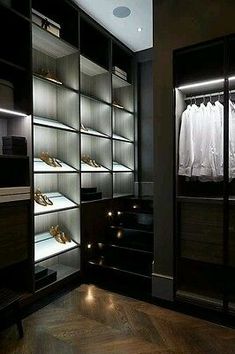 a walk in closet filled with lots of shoes and clothes hanging on the shelves next to each other