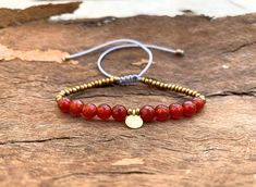 🌟 Embrace the warm, energizing vibes of the sun with our stunning Carnelian Bracelet! 🌞 Handcrafted with care and attention to detail, each bead exudes the fiery hues & natural beauty of genuine carnelian gemstones. ▽▲Details▽▲ ★Carnelian faceted round 6mm beads  ★Gold mineral hematite beads ★ hanging inoxidable brass disc ★Clever fastening to secure a perfect fit ★Adjustable length ★Allergy free/Nickel free materials ★waterproof materials  ★Made in Greece 🔶 Carnelian is renowned for its vibrant orange-red color, symbolizing courage, vitality, and passion. It's believed to boost confidence, creativity, and motivation, making it the perfect accessory for those seeking inspiration and empowerment in their daily lives. 🎁 Treat yourself or a loved one to this beautiful carnelian bracelet, Carnelian Bracelet, Carnelian Jewelry, Metallic Luster, Carnelian Beads, Jewelry Stone, Greek Words, Hematite Beads, Confidence Boost, Allergy Free