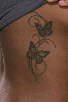 a woman with a butterfly tattoo on her stomach