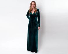 a woman in a long green velvet dress