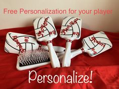 four personalized hairbrushes sitting on top of a red bed with the words, free personalization for your player