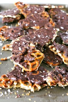 chocolate and pretzels are arranged on a baking sheet