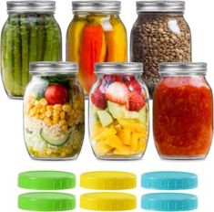 several jars filled with different types of vegetables and fruits next to each other on white background