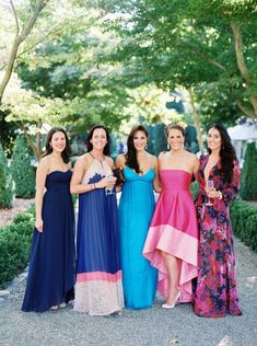 four women in dresses posing for the camera