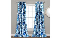 the blue and white curtains are hanging in front of a window